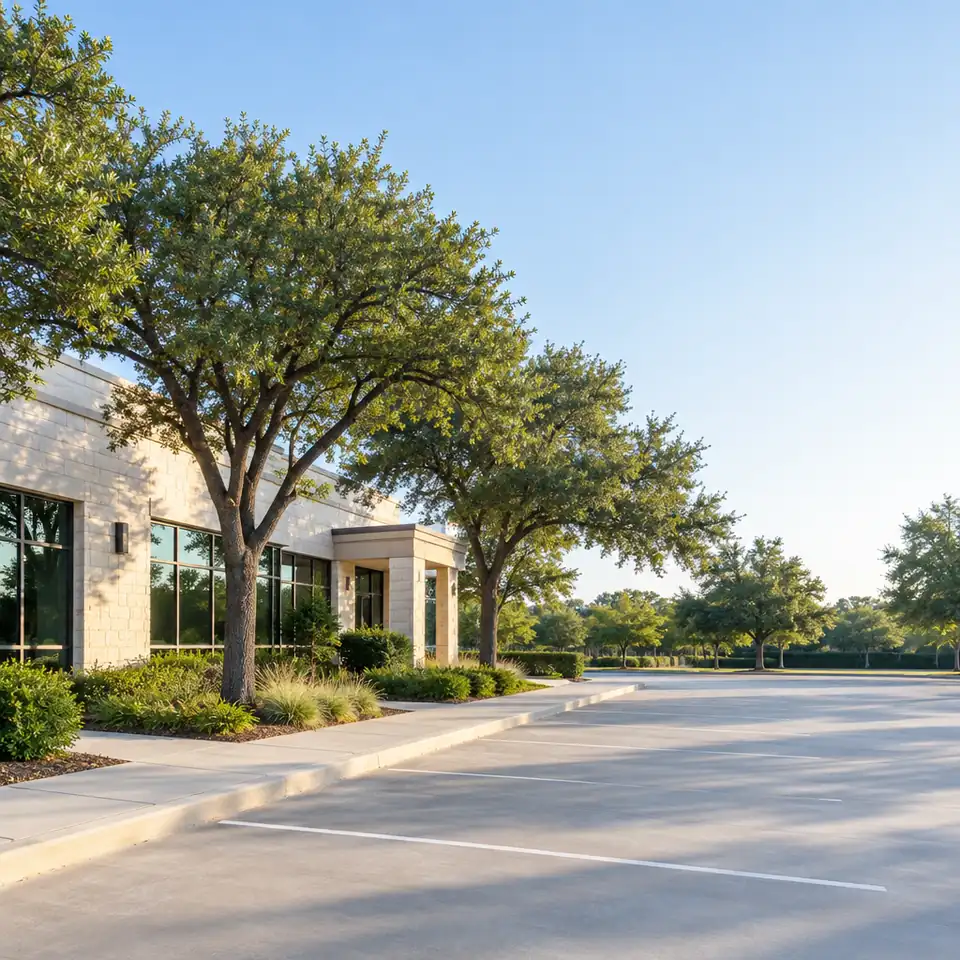 Office building and oak trees on a quiet business street in Forrestridge, Denton, Texas